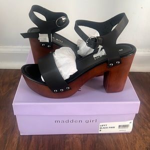 Heels. Black leather straps with wooden heels.